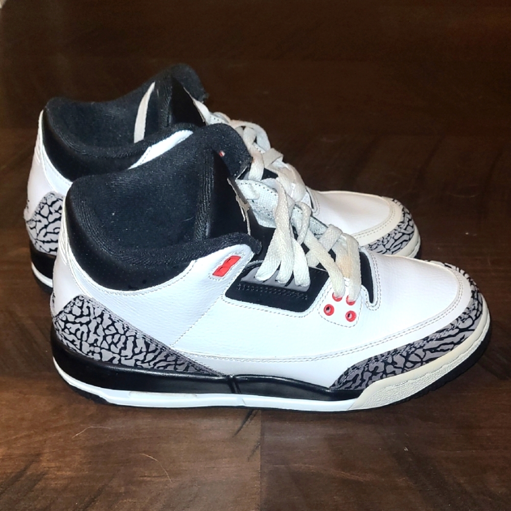 White and Black Sneakers with Red Accents